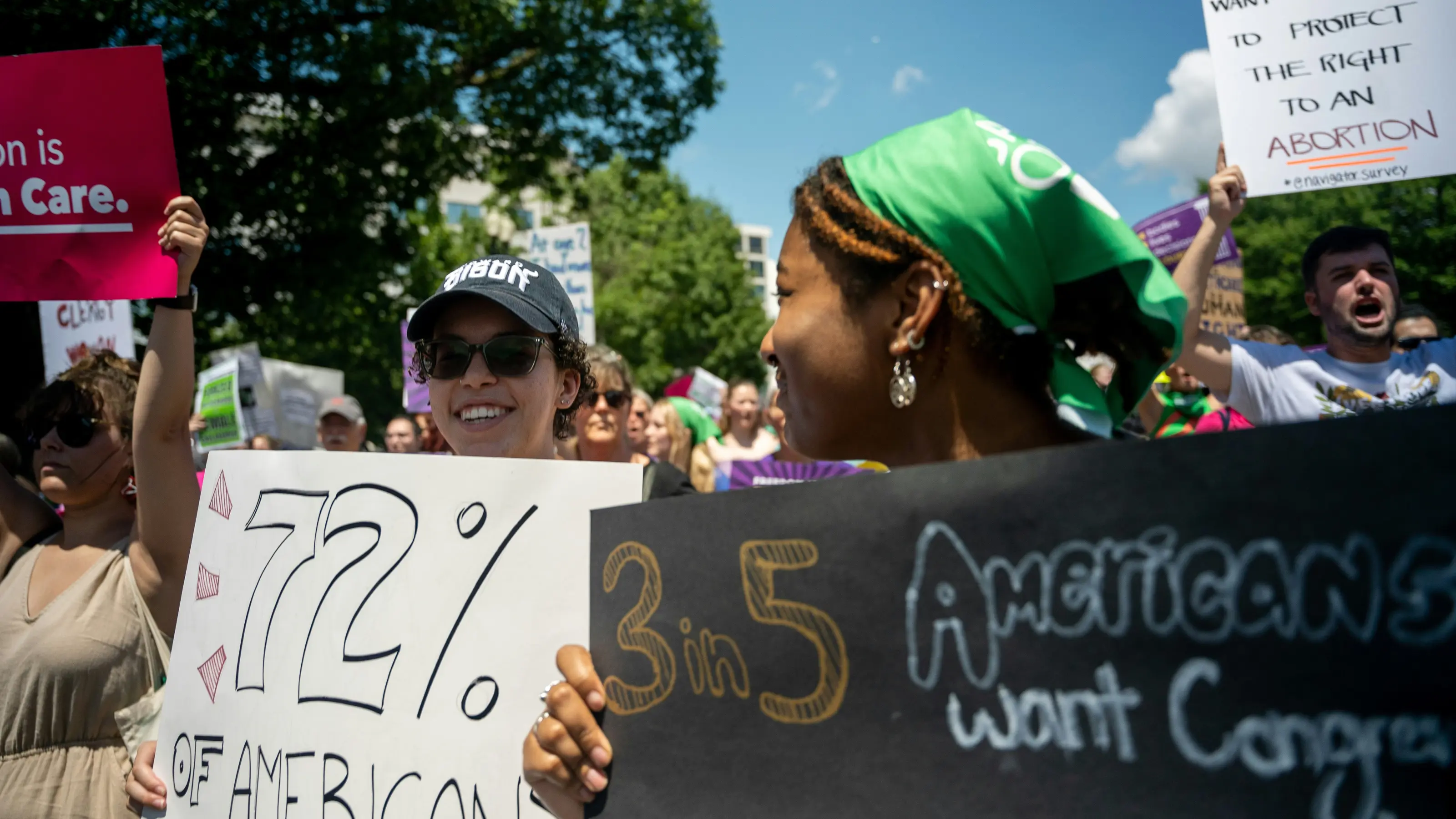 Activists at a rally holding signs